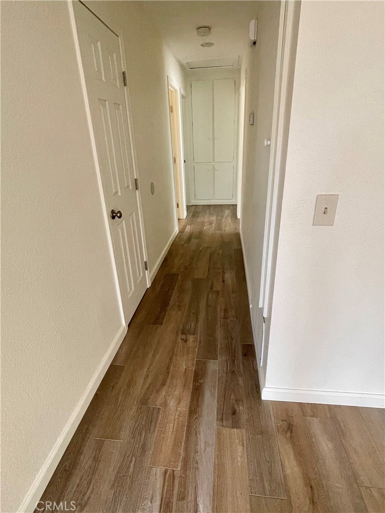 4317 Ardsley Court Riverside, CA 92505 - Photo 5 of 7 a view of a hallway with wooden floor and staircase