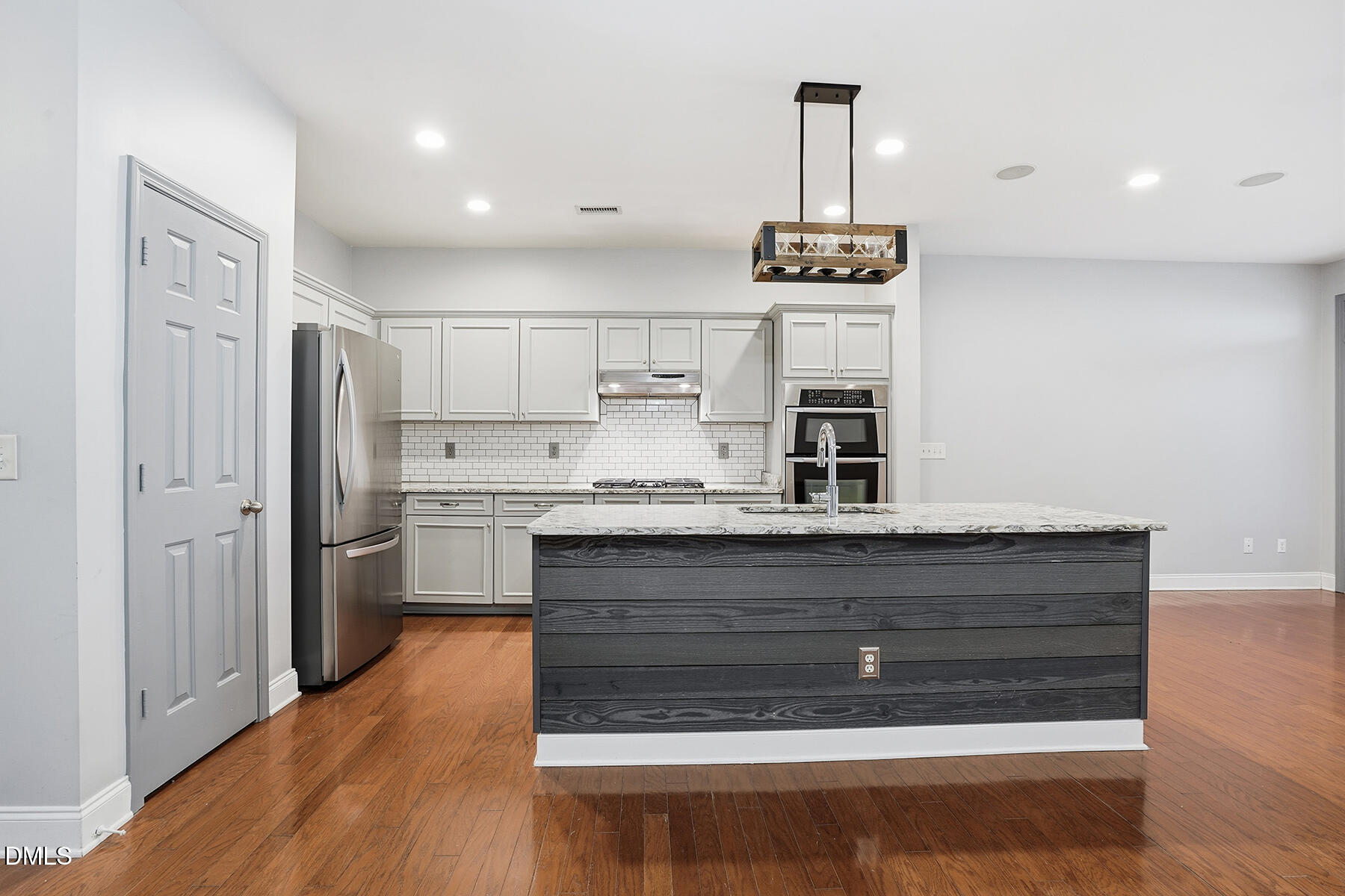 520 Camden Yards Way Cary, NC 27519 - Photo 14 of 30 a kitchen with stainless steel appliances granite countertop a refrigerator stove and white cabinets