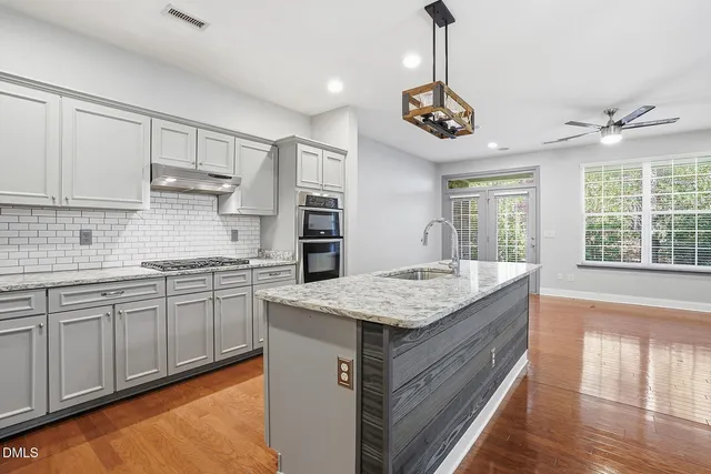a kitchen with center island and stainless steel appliances