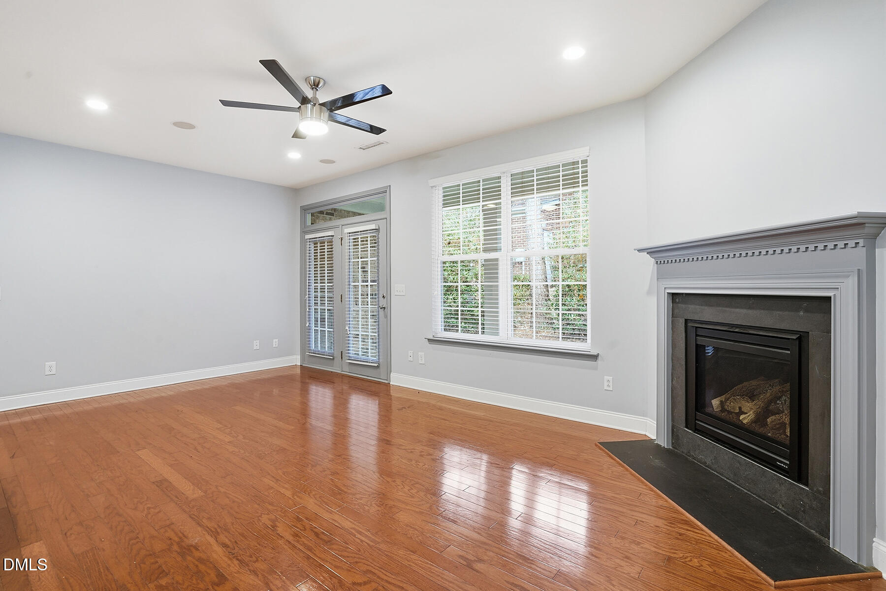 520 Camden Yards Way Cary, NC 27519 - Photo 18 of 30 a view of an empty room with wooden floor fireplace and a window