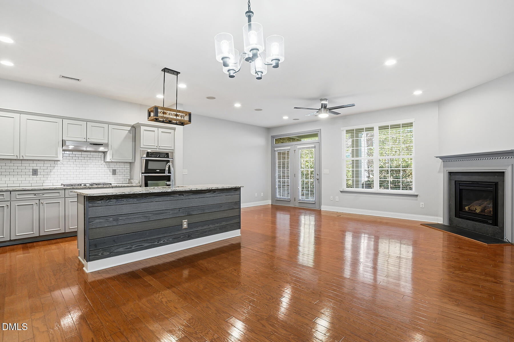 520 Camden Yards Way Cary, NC 27519 - Photo 9 of 30 a kitchen with stainless steel appliances granite countertop a stove and a wooden floors