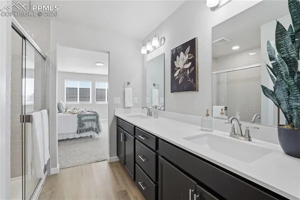 a bathroom with a sink double vanity granite tub and shower