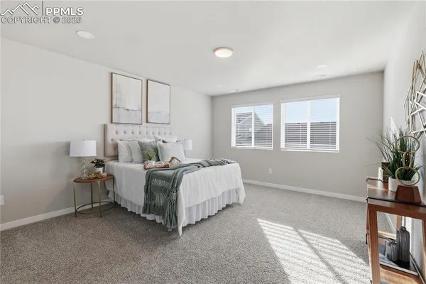 a bed room with a bed and a potted plant