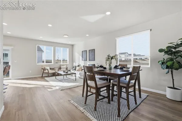 a view of a dining room with furniture and wooden floor