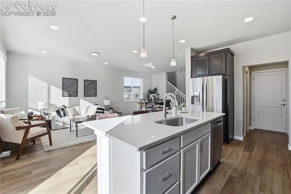 a kitchen with a sink stove and refrigerator