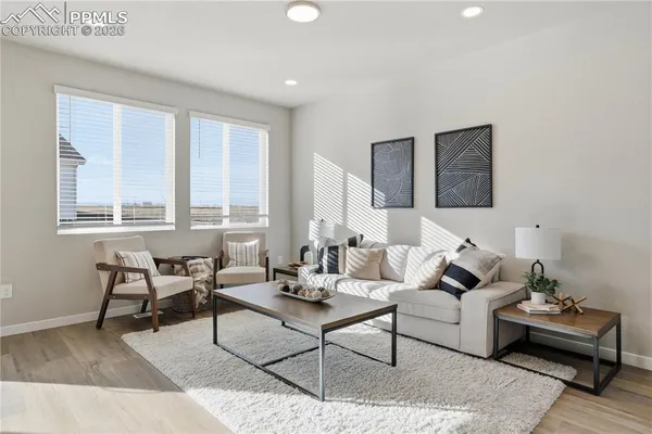 a living room with furniture and a large window
