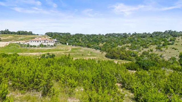 a view of residential houses with outdoor space and trees
