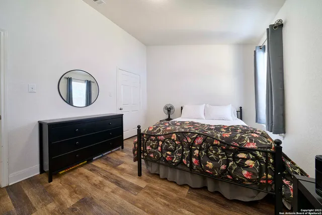 a bedroom with a bed and a dresser
