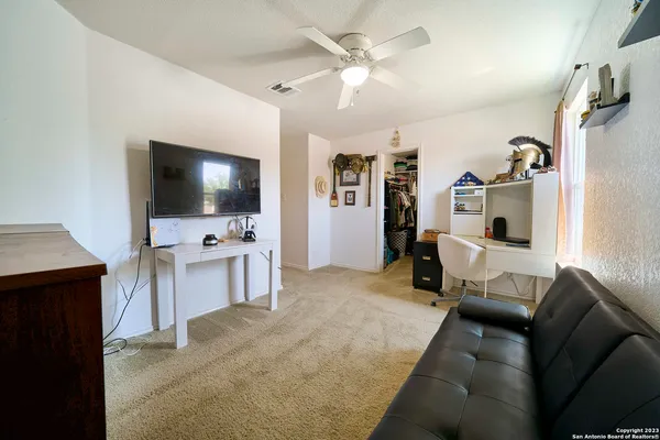 a bedroom with a bed and ceiling fan