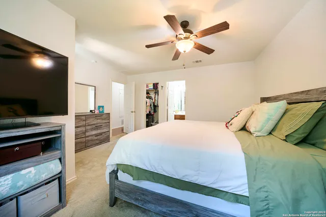 a bathroom with a sink a toilet and shower curtain