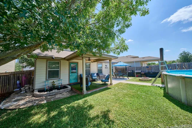 a backyard of a house with table and chairs