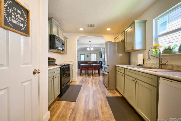 a kitchen with stainless steel appliances granite countertop a refrigerator and a sink