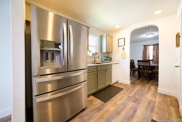 a kitchen with stainless steel appliances a refrigerator sink and cabinets
