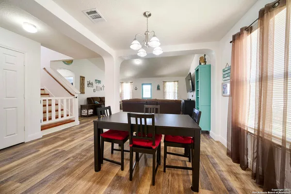 a view of a dining room with furniture and a chandelier