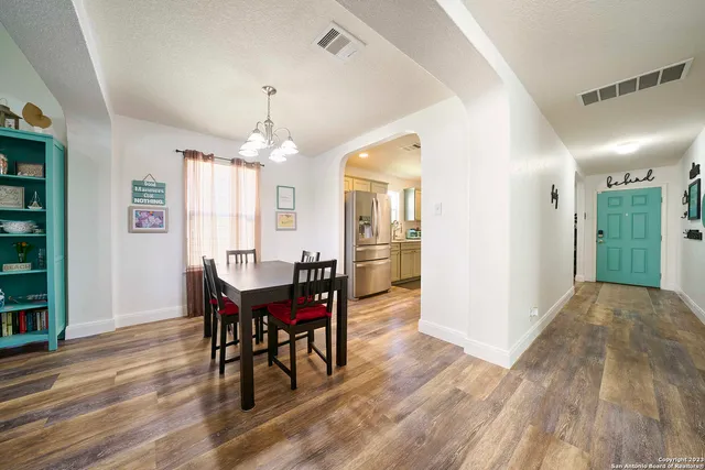 a view of a dining room with furniture and window