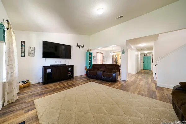 a living room with furniture and a flat screen tv