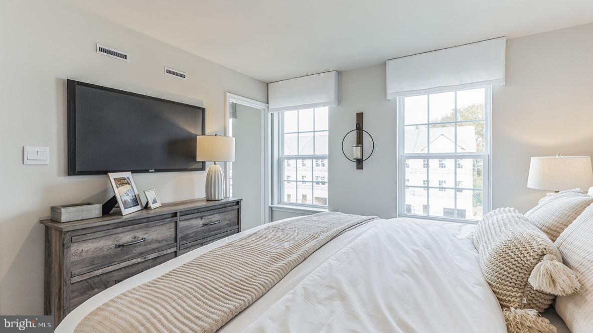3080 Martha Way Pennsburg, PA 18073 - Photo 20 of 24 a bedroom with a bed and a flat screen tv on dresser