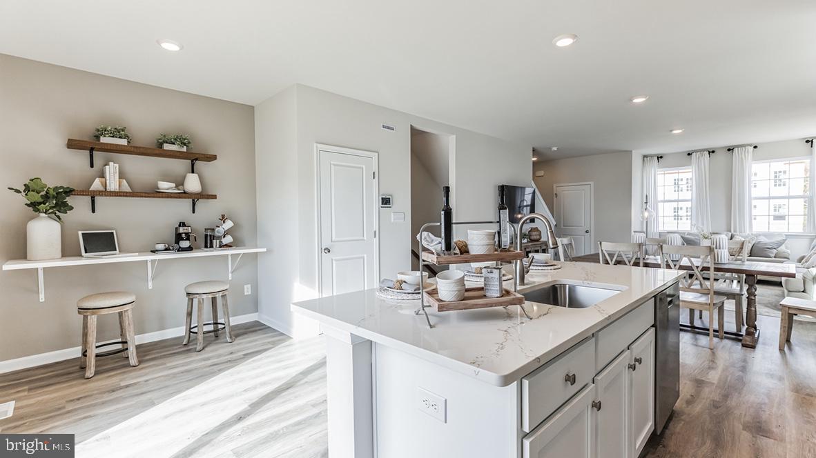 3080 Martha Way Pennsburg, PA 18073 - Photo 2 of 24 a living room with stainless steel appliances kitchen island granite countertop a sink and chairs