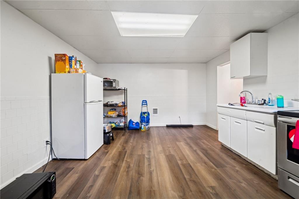 425 Agatha Street Pitcairn, PA 15140 - Photo 15 of 34 a view of a kitchen with fridge and wooden floor