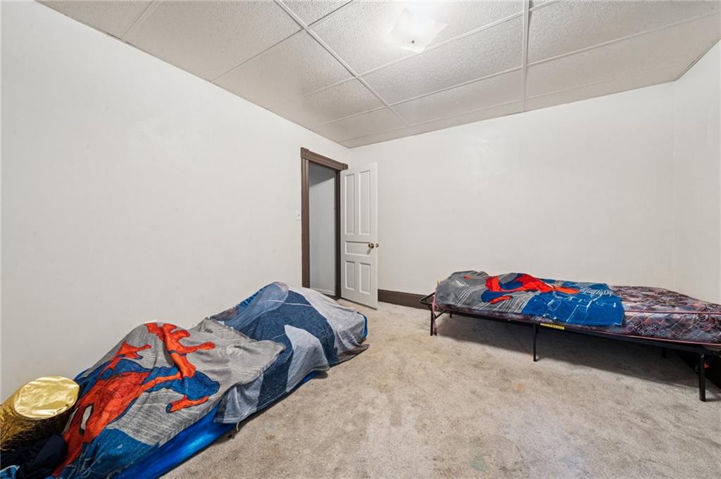 425 Agatha Street Pitcairn, PA 15140 - Photo 17 of 34 a bedroom with two bed and a room with wooden floor