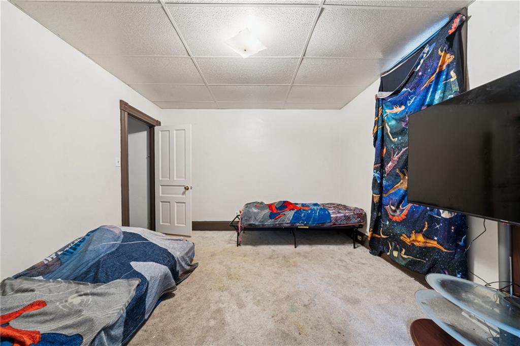 425 Agatha Street Pitcairn, PA 15140 - Photo 18 of 34 a bedroom with bed and a chandelier