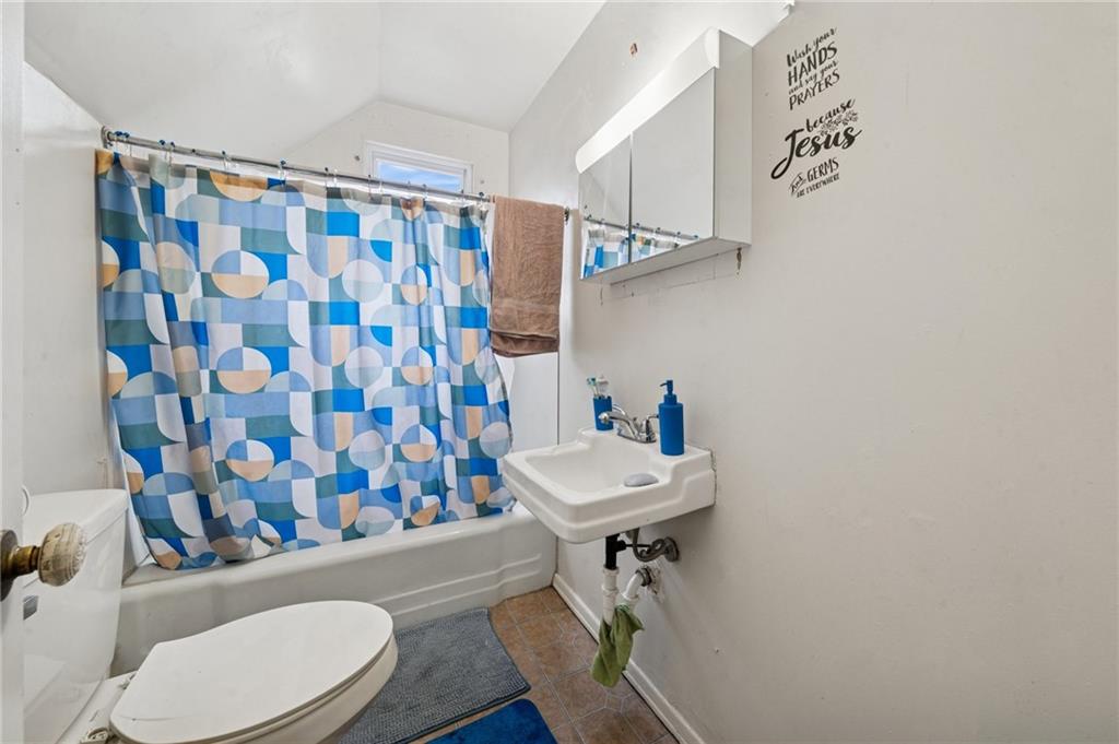 425 Agatha Street Pitcairn, PA 15140 - Photo 20 of 34 a bathroom with a sink a toilet and shower curtain