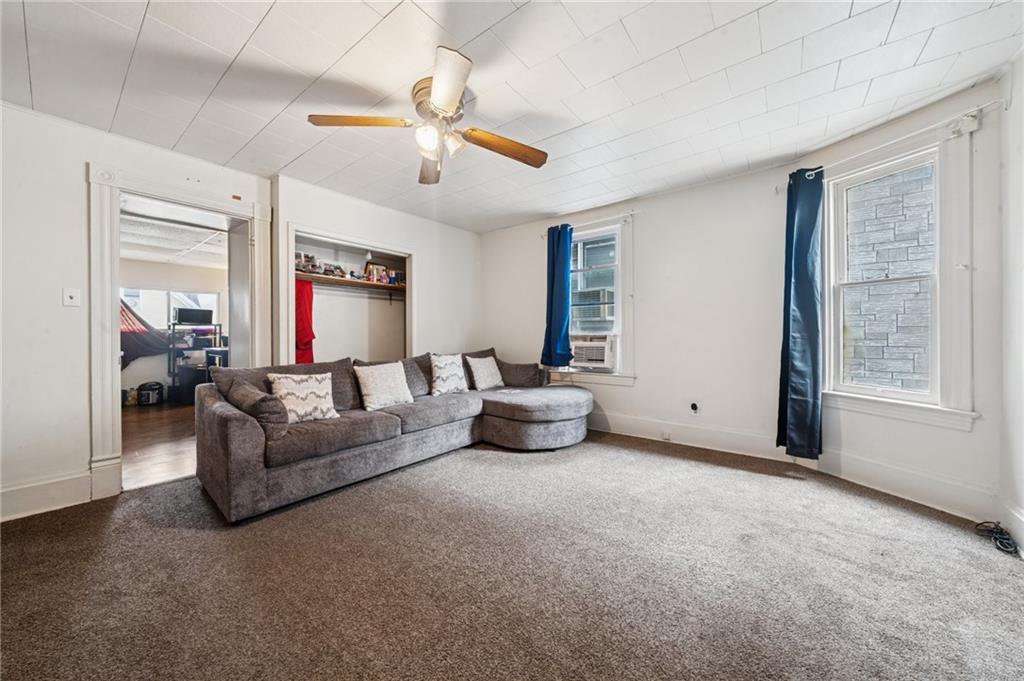 425 Agatha Street Pitcairn, PA 15140 - Photo 6 of 34 a living room with furniture and a chandelier