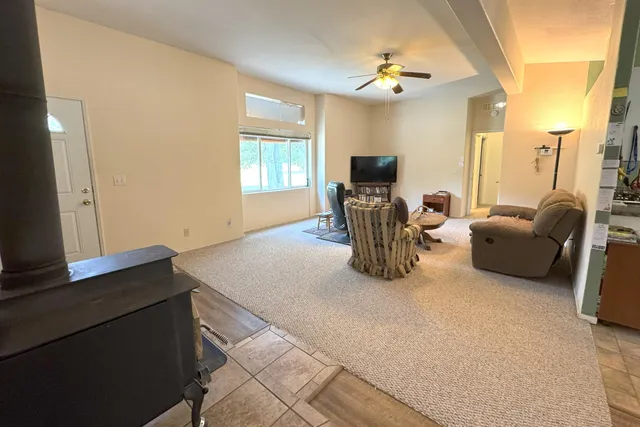 a living room with furniture a chandelier and a window