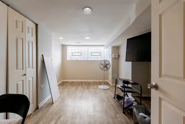 a view of a livingroom with wooden floor and a window