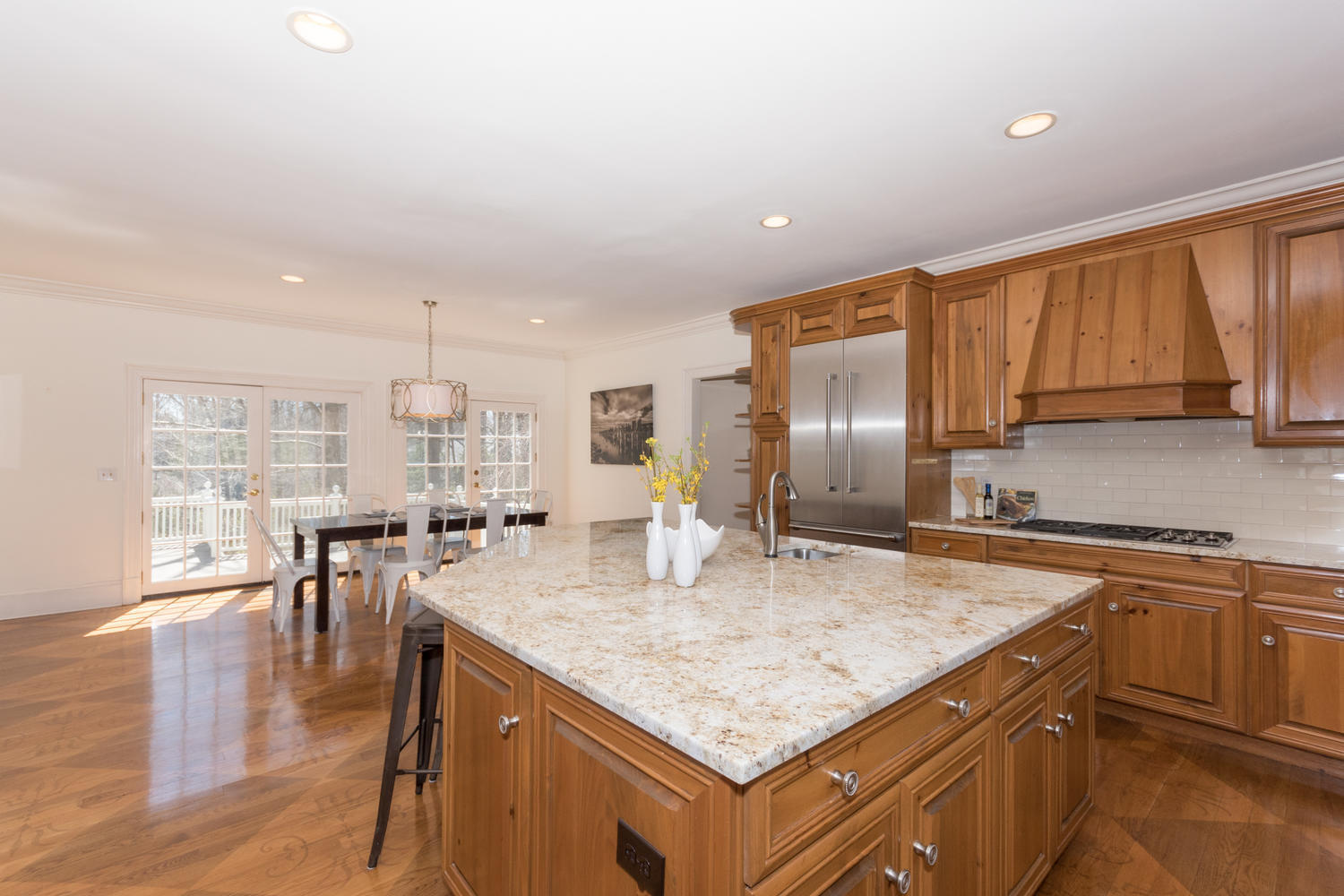 123 Lone Tree Farm Road New Canaan, CT 06840 - Photo 12 of 22 a kitchen with a stove a refrigerator a sink a dining table and chairs