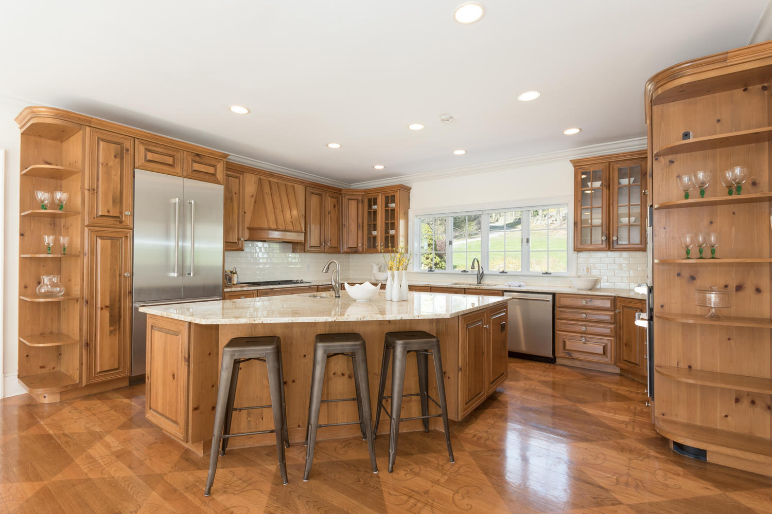 123 Lone Tree Farm Road New Canaan, CT 06840 - Photo 13 of 22 a kitchen with kitchen island granite countertop wooden cabinets and refrigerator