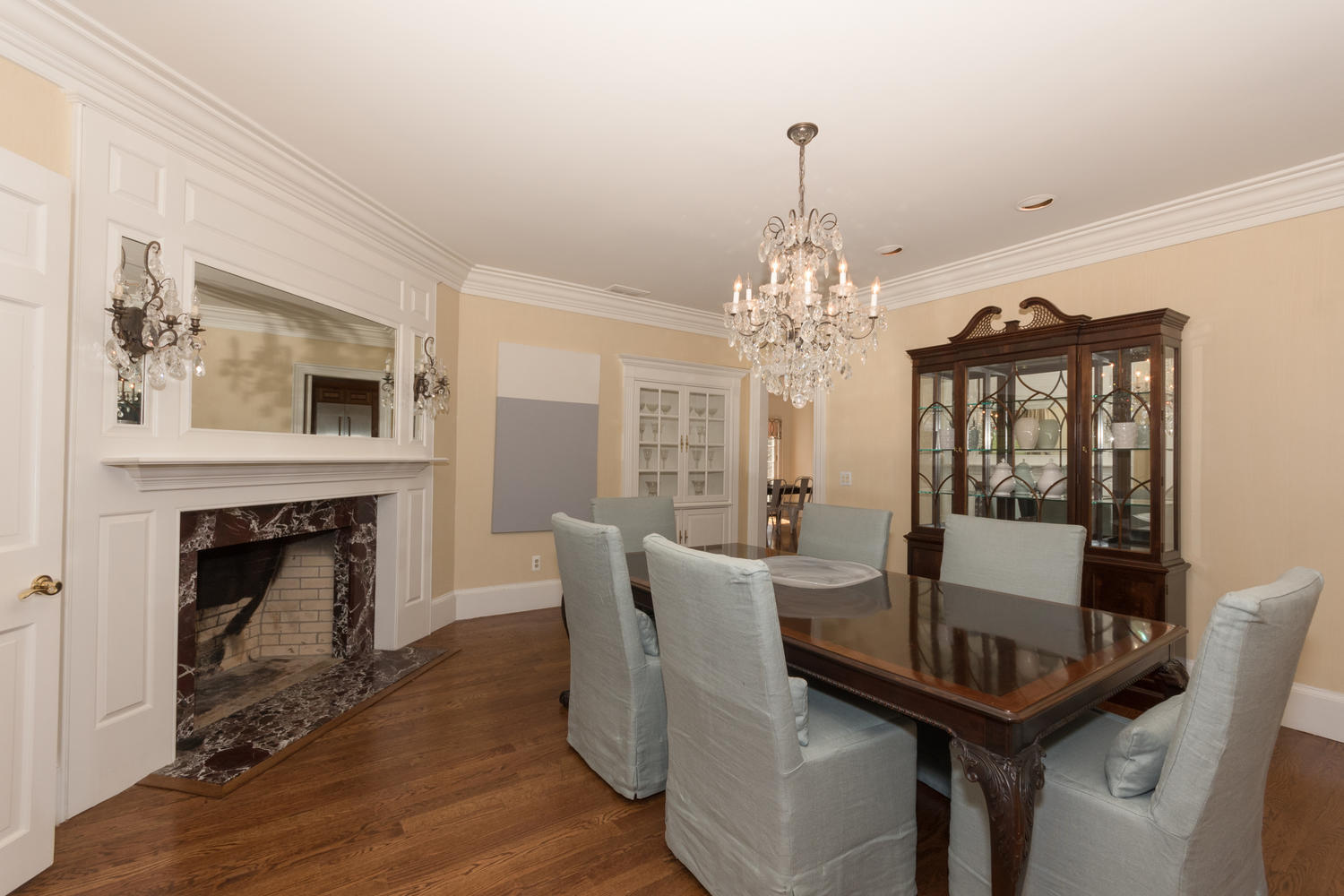 123 Lone Tree Farm Road New Canaan, CT 06840 - Photo 6 of 22 a dining room with furniture a fireplace and wooden floor