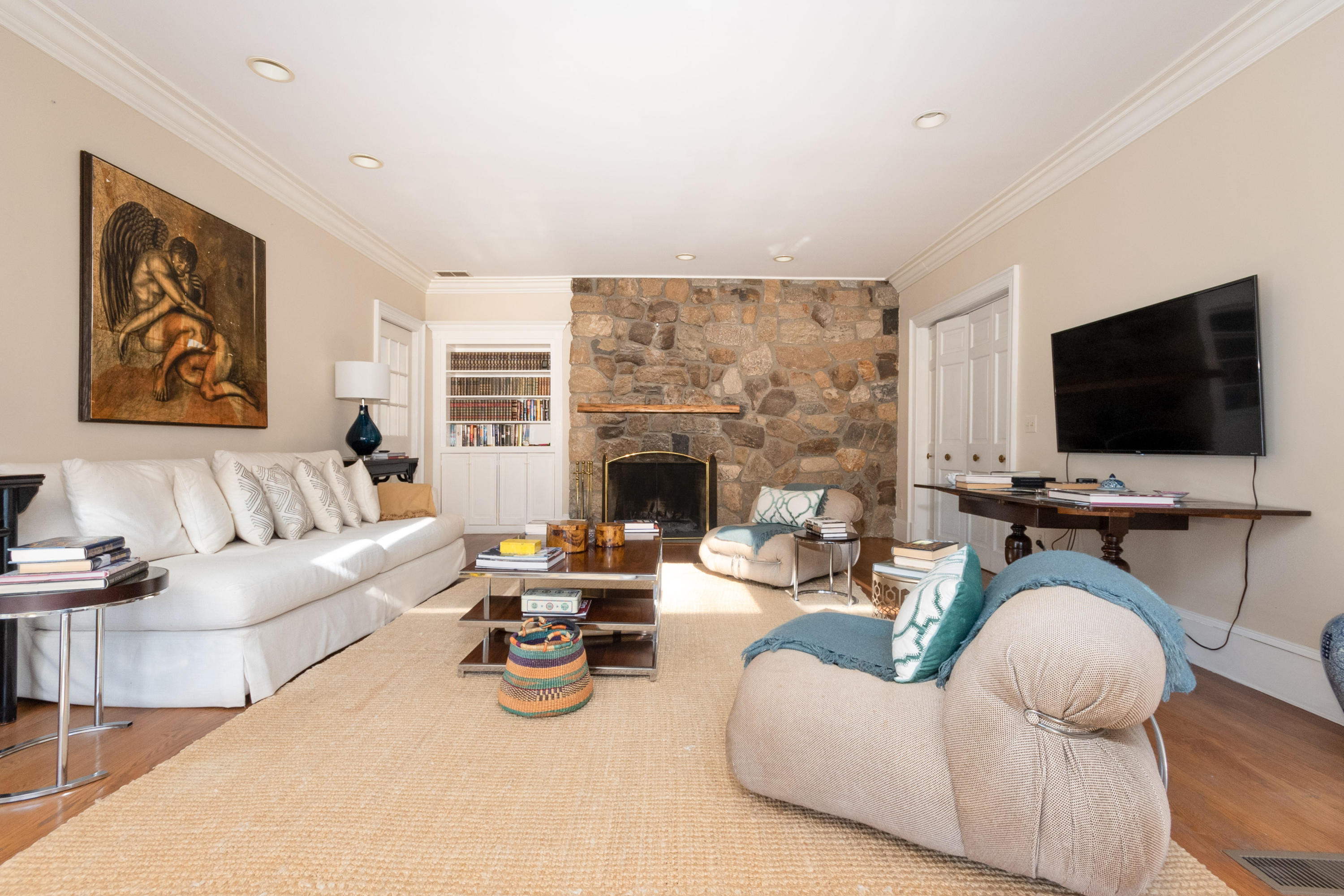 123 Lone Tree Farm Road New Canaan, CT 06840 - Photo 9 of 22 a living room with furniture a flat screen tv and a fireplace