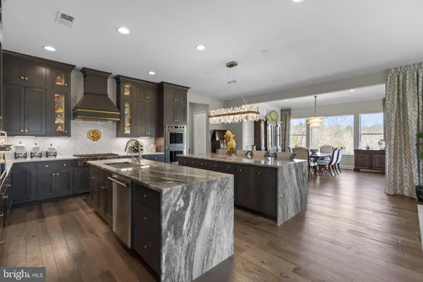 a kitchen with lots of counter top space and painting on the wall