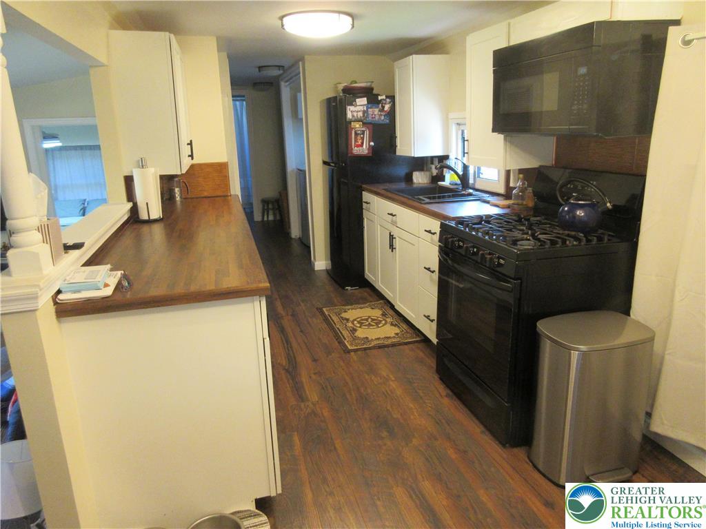 246 Poplar Street Bath, PA 18014 - Photo 13 of 20 a kitchen with sink refrigerator and stove