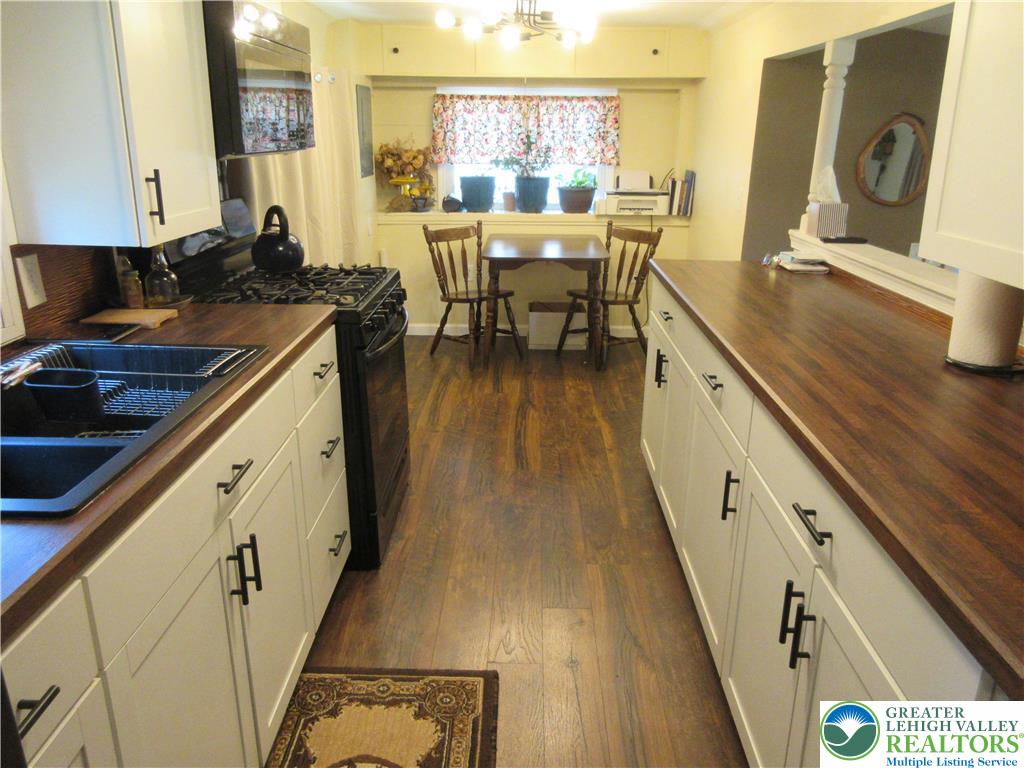 246 Poplar Street Bath, PA 18014 - Photo 14 of 20 a kitchen with wooden cabinets and sink