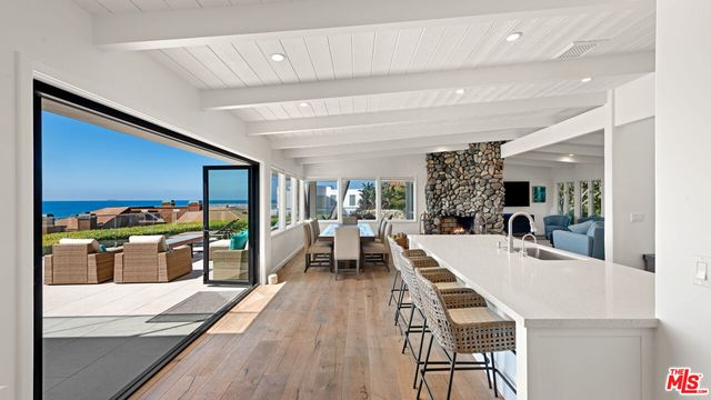 a view of a dining hall with furniture and wooden floor