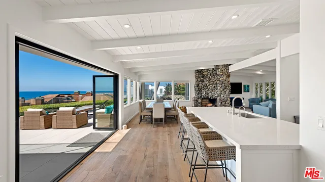 a view of a dining hall with furniture and wooden floor