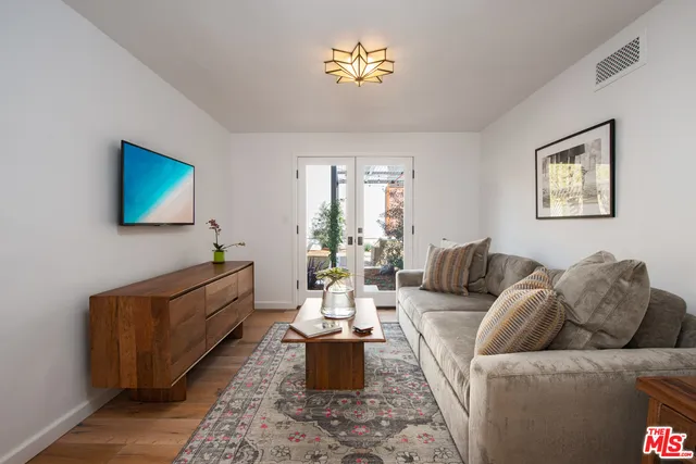 a living room with furniture flowerpot and window