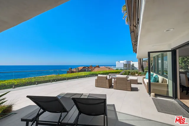 a view of a swimming pool and an outdoor seating