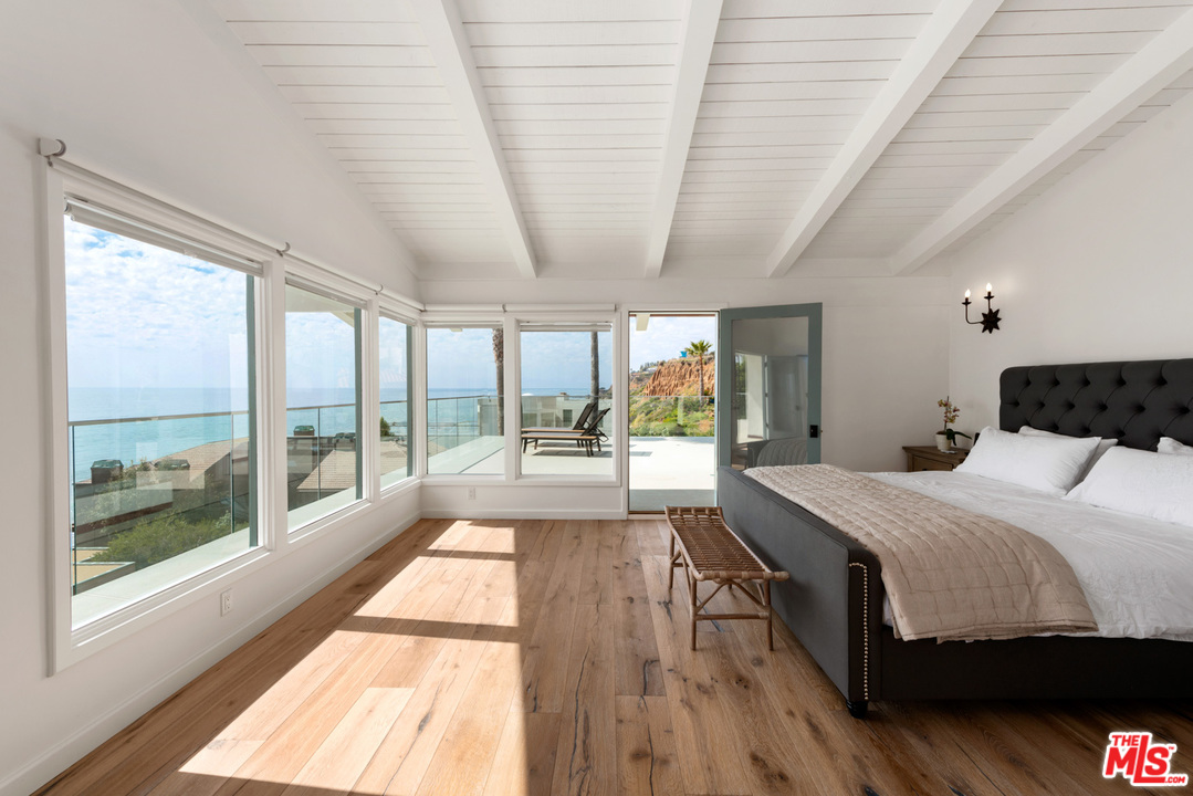 32054 Pacific Coast Highway Malibu, CA 90265 - Photo 25 of 48 a bedroom with a large bed and a large window
