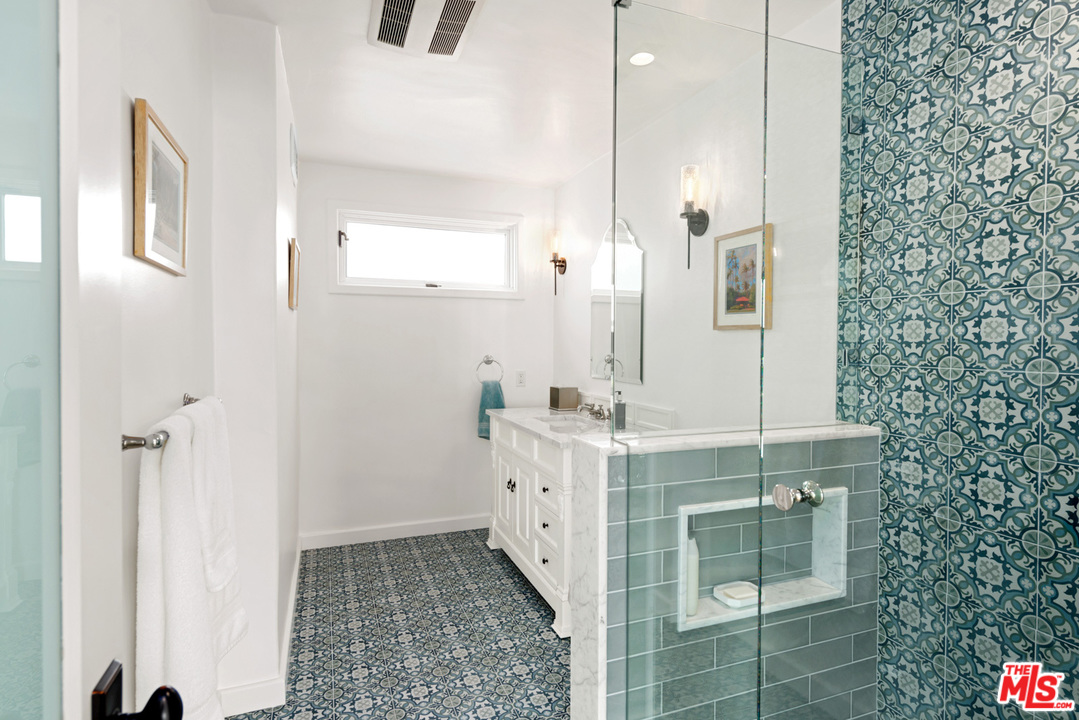 32054 Pacific Coast Highway Malibu, CA 90265 - Photo 35 of 48 a spacious bathroom with a double vanity sink a mirror and a shower