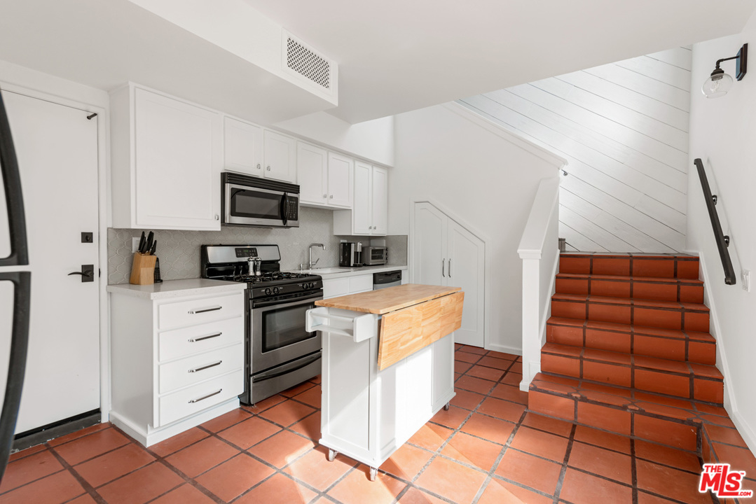 32054 Pacific Coast Highway Malibu, CA 90265 - Photo 37 of 48 a kitchen with white cabinets and appliances