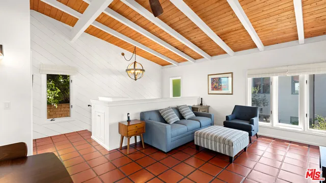 a living room with furniture and next to a window