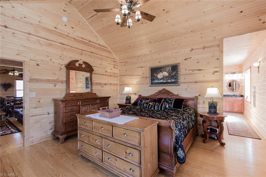 308 Warren Way Purlear, NC 28665 - Photo 17 of 29 Spacious Main Level Master Bedroom with ensuite bathroom, large walk-in closet, and a covered porch with breathtaking views!