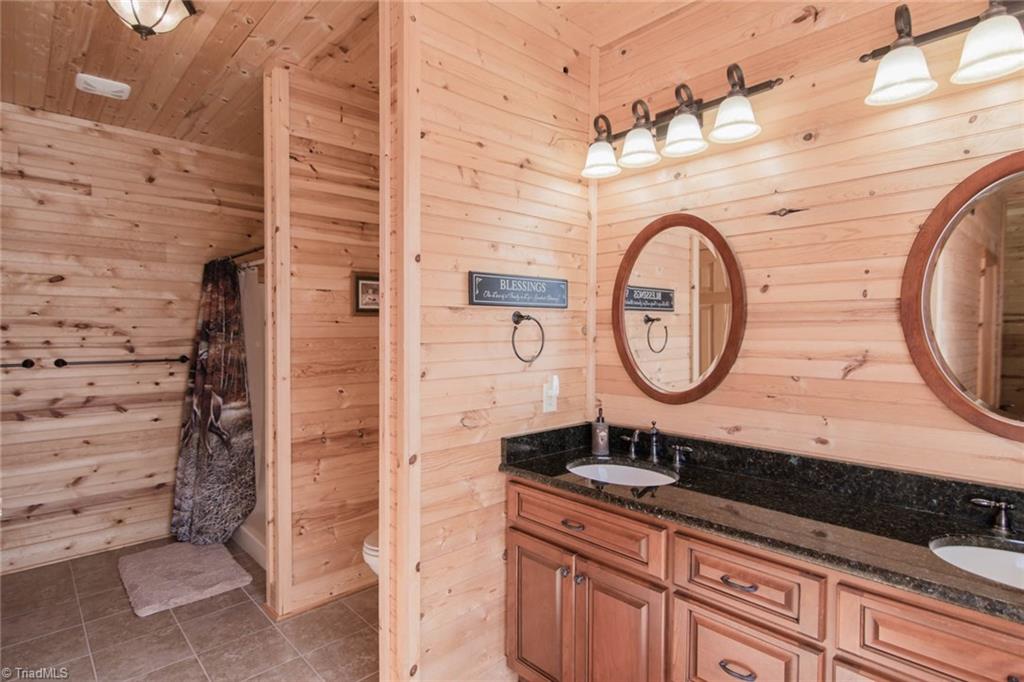 308 Warren Way Purlear, NC 28665 - Photo 18 of 29 Ensuite Master Bathroom with double vanity and linen closet. Shower has double shower heads. There is enough room to add washer and dryer hookups if single level living is desired.