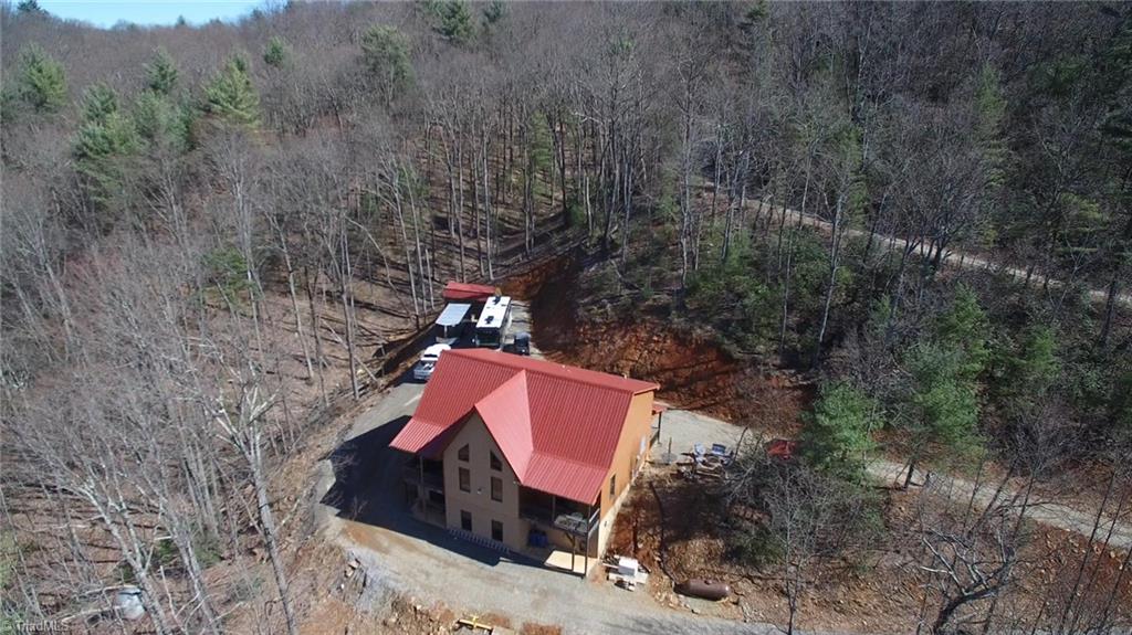 308 Warren Way Purlear, NC 28665 - Photo 6 of 29 Aerial View of the back elevation. There is a generous parking area out front for all of the toys...ATV, Trailer, RV, Vehicles, and there is even a large 10x20 storage shed!