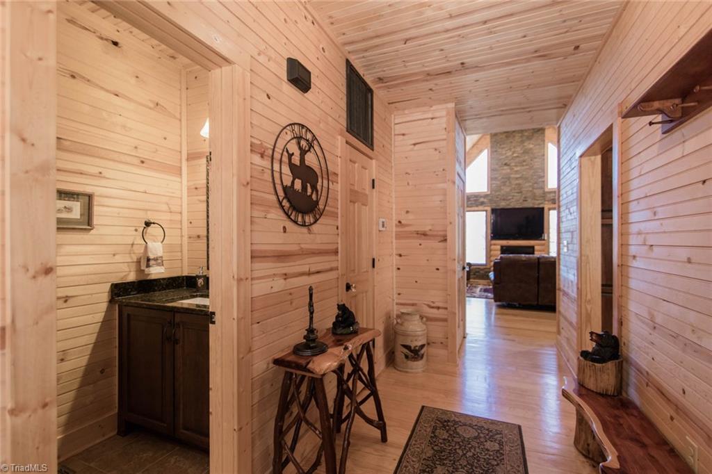 308 Warren Way Purlear, NC 28665 - Photo 7 of 29 Foyer with Half Bath and Pantry leads to the Great Room with gas log fireplace. The Kitchen is on the right.