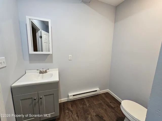 a bathroom with a sink mirror and toilet