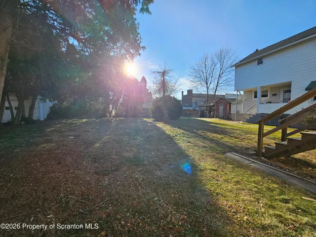 a view of a backyard with swimming pool